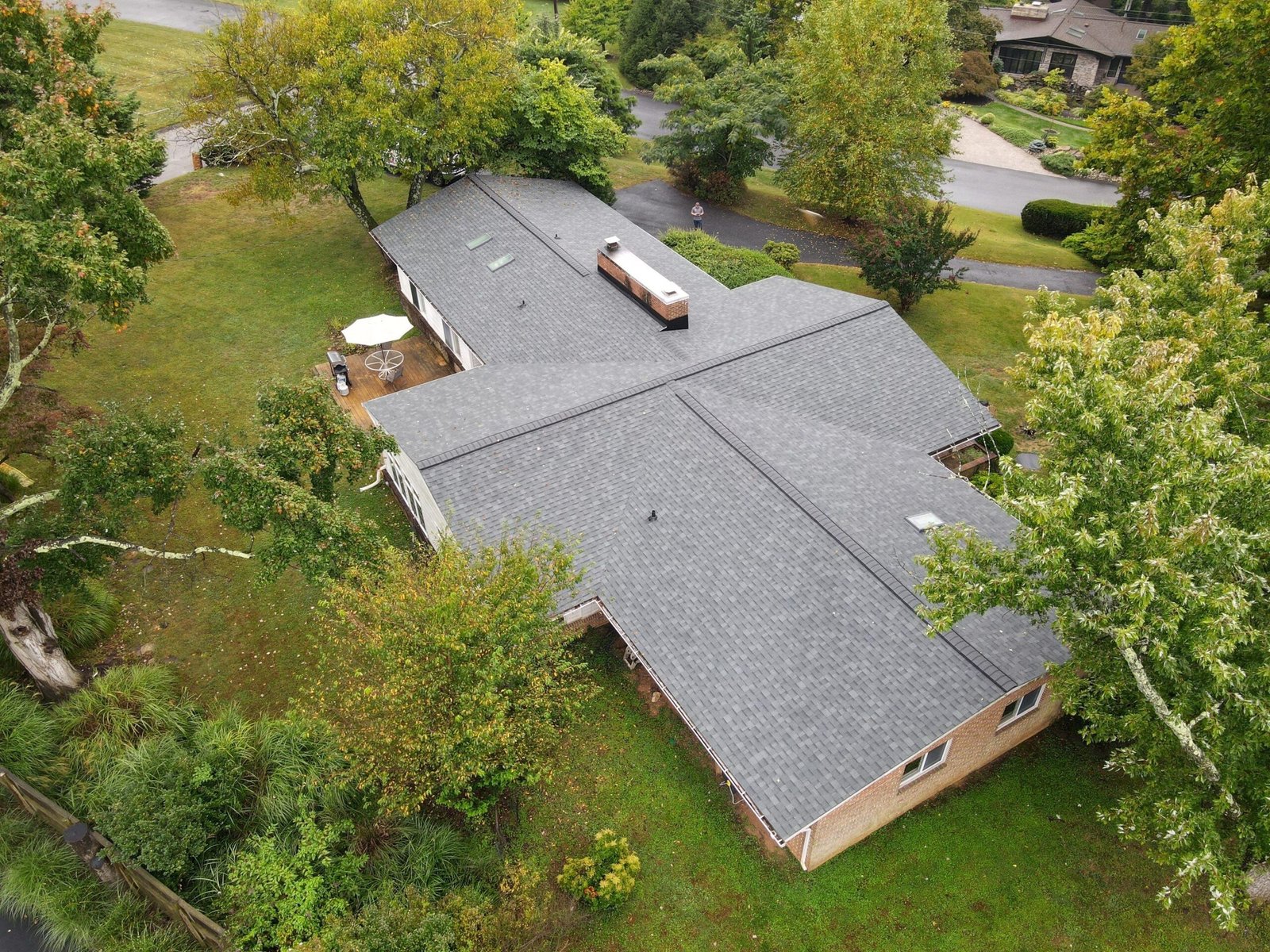 Completed shingle roof replacement on a Maryland split-level home