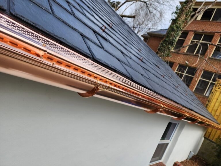 New copper gutter running along the edge of a Maryland roof