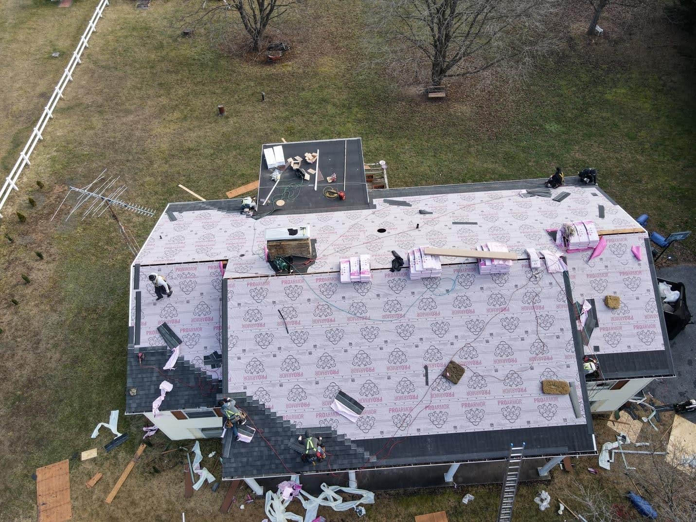 Aerial view of a completed roof on a dormered Cape Cod house