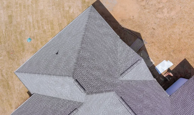 Aerial view of new asphalt shingles on a roof, illustrating quality roofing for home repairs.